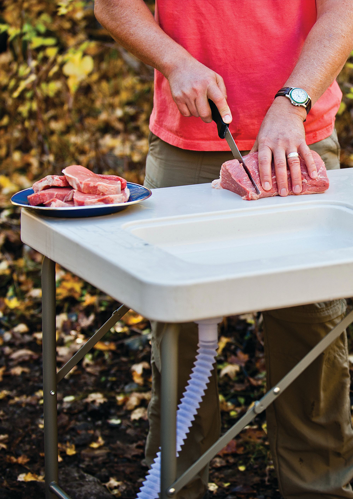 Preparing food outdoors on a ColdCreek table